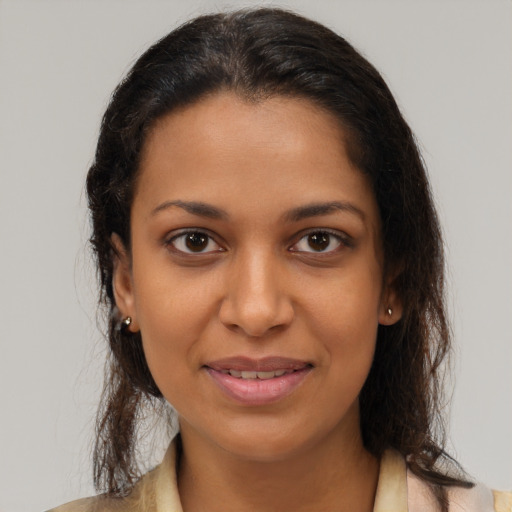 Joyful black young-adult female with medium  brown hair and brown eyes