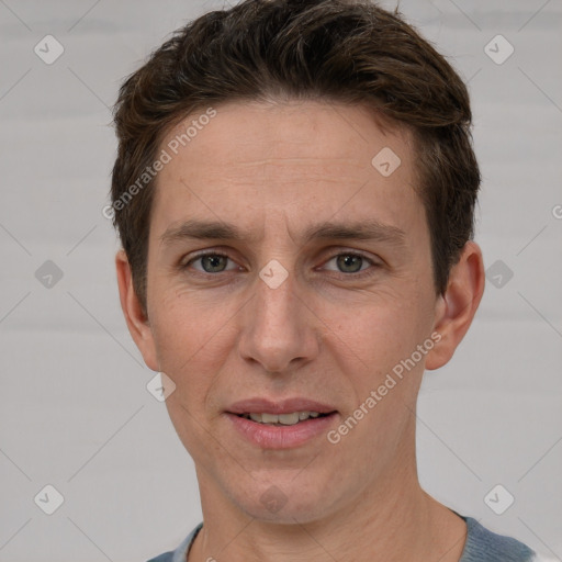 Joyful white adult male with short  brown hair and grey eyes