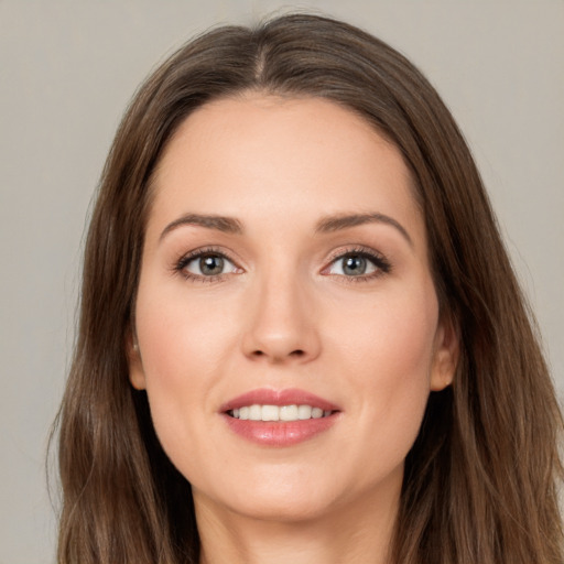 Joyful white young-adult female with long  brown hair and brown eyes