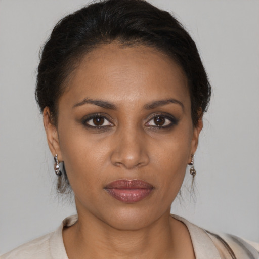 Joyful black young-adult female with medium  brown hair and brown eyes