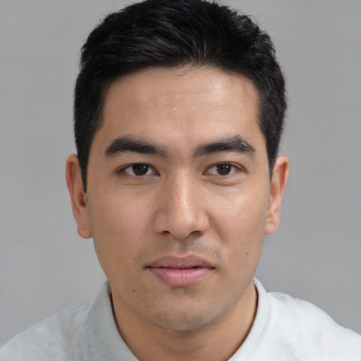 Joyful asian young-adult male with short  brown hair and brown eyes
