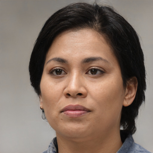 Joyful asian adult female with medium  black hair and brown eyes