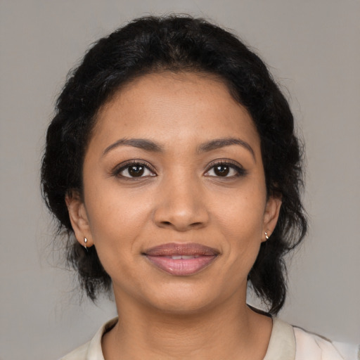 Joyful latino young-adult female with medium  black hair and brown eyes