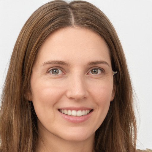 Joyful white young-adult female with long  brown hair and brown eyes