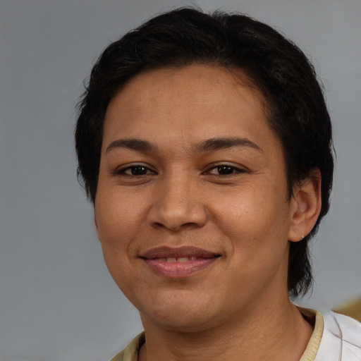 Joyful latino adult female with short  brown hair and brown eyes