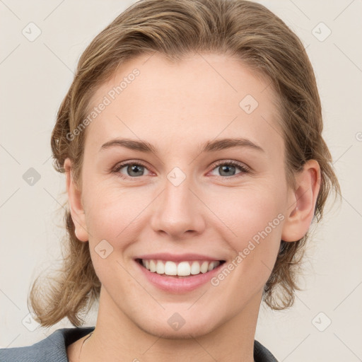 Joyful white young-adult female with medium  brown hair and blue eyes