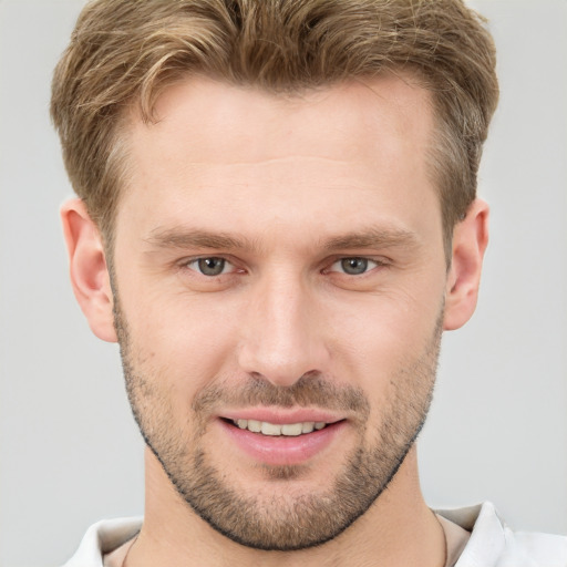 Joyful white young-adult male with short  brown hair and brown eyes