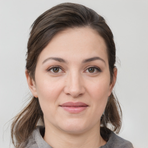 Joyful white young-adult female with medium  brown hair and brown eyes