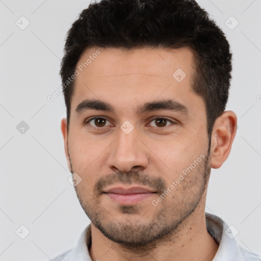 Joyful white young-adult male with short  black hair and brown eyes