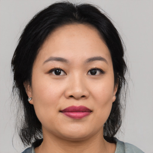 Joyful asian young-adult female with medium  black hair and brown eyes