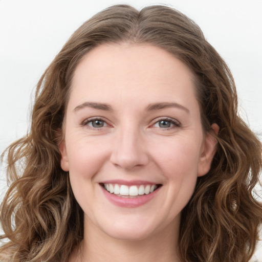 Joyful white young-adult female with long  brown hair and green eyes