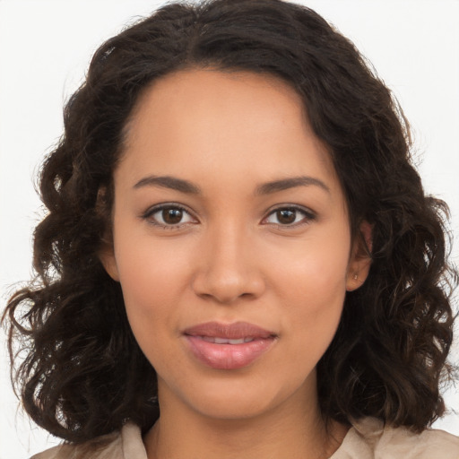 Joyful latino young-adult female with long  brown hair and brown eyes