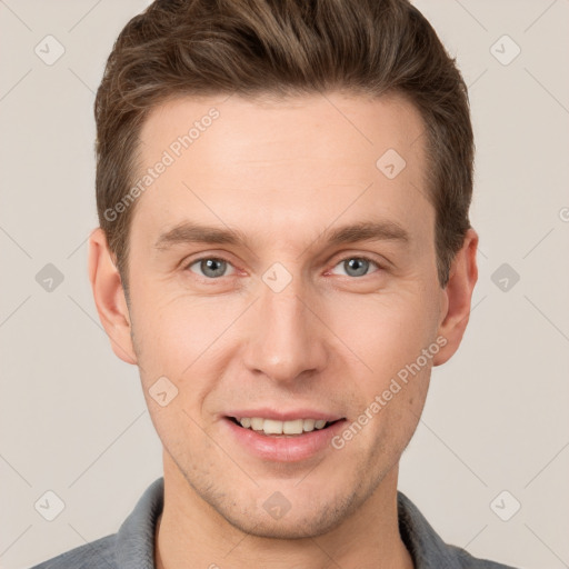 Joyful white young-adult male with short  brown hair and grey eyes