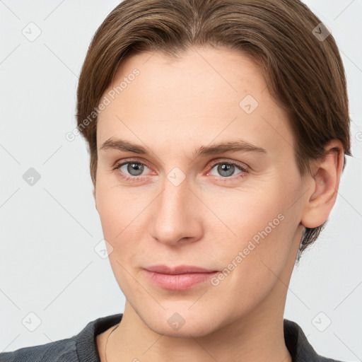 Joyful white young-adult female with short  brown hair and grey eyes