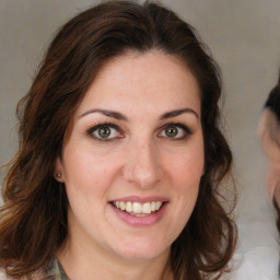 Joyful white young-adult female with medium  brown hair and green eyes