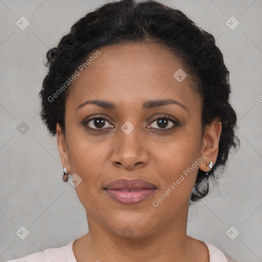 Joyful black young-adult female with short  black hair and brown eyes