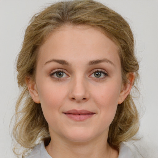 Joyful white young-adult female with medium  brown hair and blue eyes