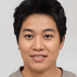 Joyful asian young-adult male with short  brown hair and brown eyes