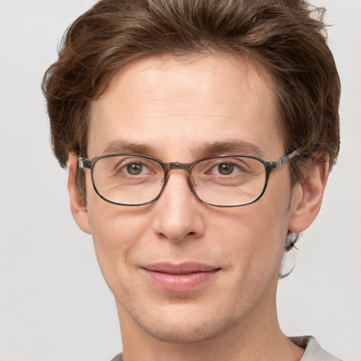 Joyful white adult male with short  brown hair and grey eyes