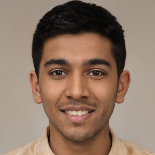 Joyful latino young-adult male with short  black hair and brown eyes