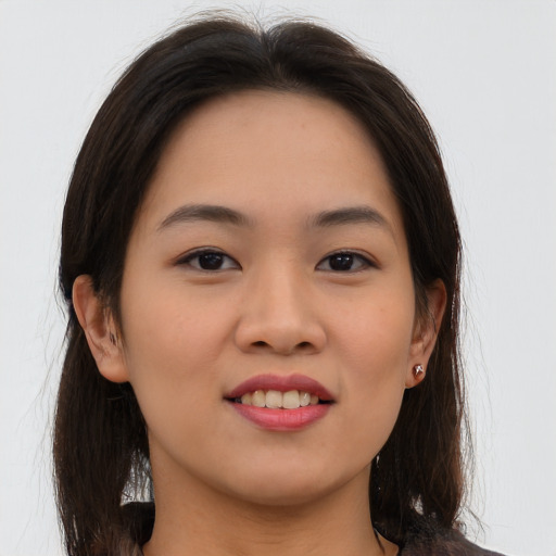 Joyful asian young-adult female with long  brown hair and brown eyes