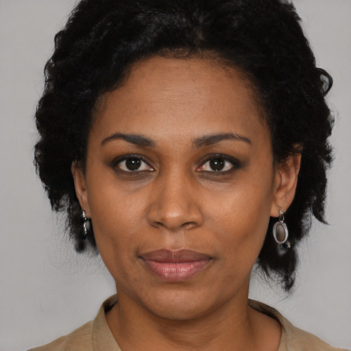 Joyful latino adult female with short  black hair and brown eyes