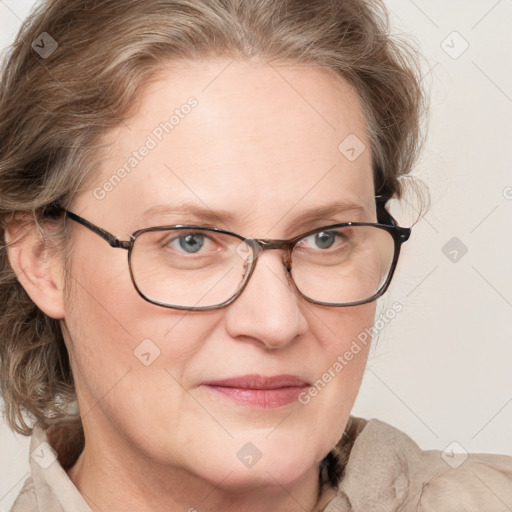 Joyful white adult female with medium  brown hair and blue eyes