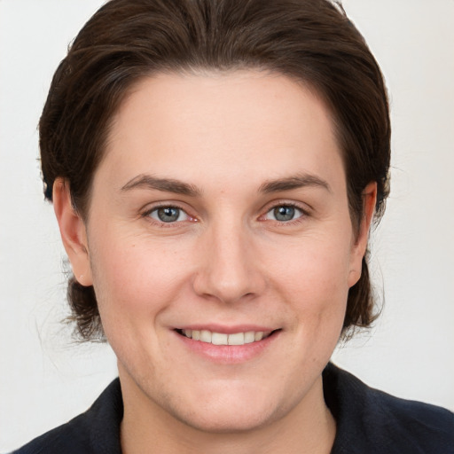 Joyful white young-adult female with medium  brown hair and grey eyes