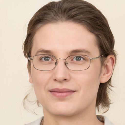 Joyful white adult female with medium  brown hair and grey eyes