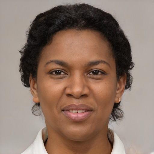 Joyful black adult female with short  brown hair and brown eyes