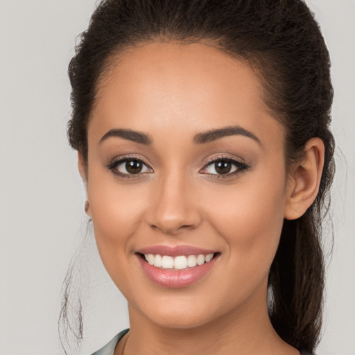 Joyful white young-adult female with long  brown hair and brown eyes