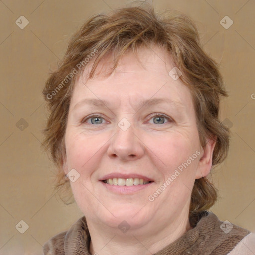 Joyful white adult female with medium  brown hair and blue eyes