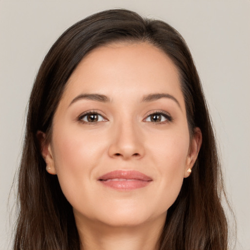 Joyful white young-adult female with long  brown hair and brown eyes