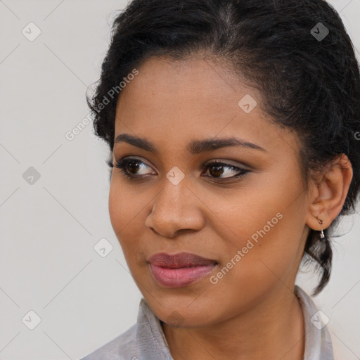 Joyful black young-adult female with long  brown hair and brown eyes