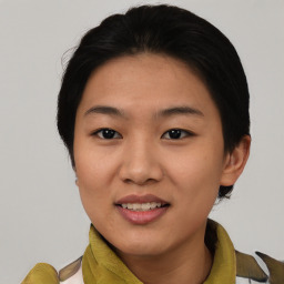 Joyful asian young-adult female with medium  black hair and brown eyes