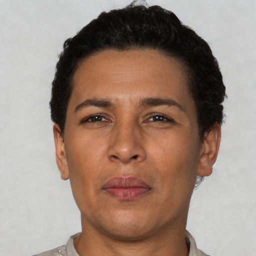 Joyful latino adult male with short  brown hair and brown eyes