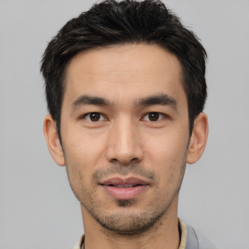 Joyful white young-adult male with short  black hair and brown eyes