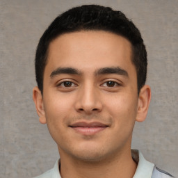 Joyful latino young-adult male with short  black hair and brown eyes