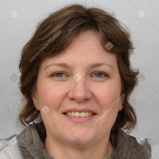 Joyful white adult female with medium  brown hair and blue eyes