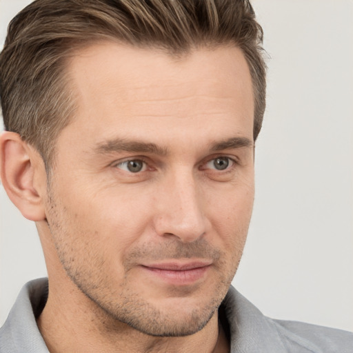 Joyful white adult male with short  brown hair and brown eyes