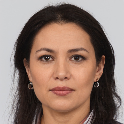 Joyful white adult female with long  brown hair and brown eyes