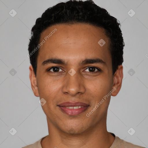 Joyful latino young-adult male with short  black hair and brown eyes