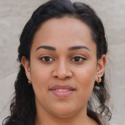 Joyful latino young-adult female with long  brown hair and brown eyes