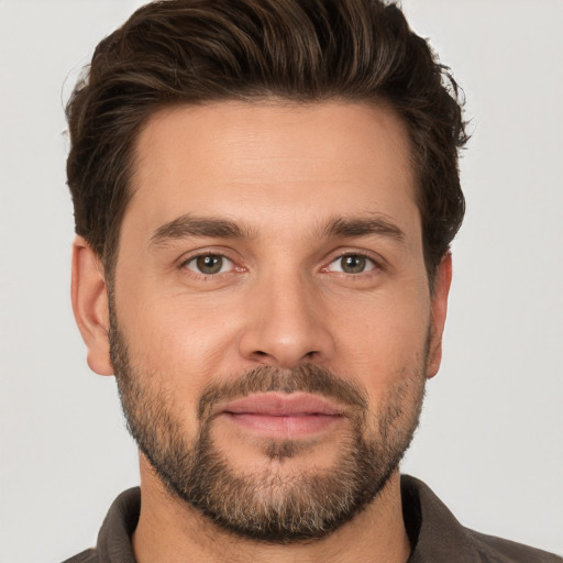 Joyful white young-adult male with short  brown hair and brown eyes