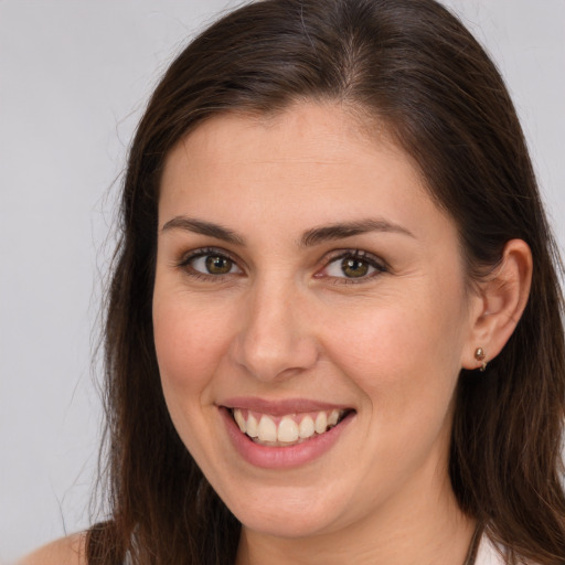 Joyful white young-adult female with long  brown hair and brown eyes