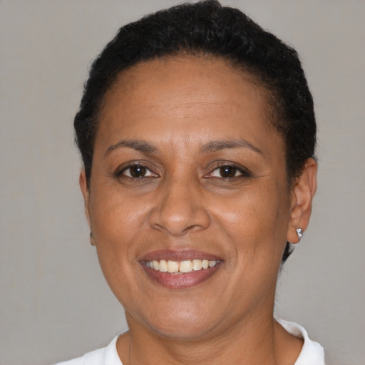Joyful black adult female with short  brown hair and brown eyes