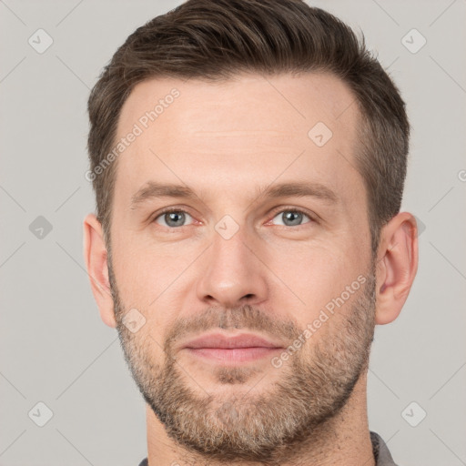 Joyful white adult male with short  brown hair and grey eyes