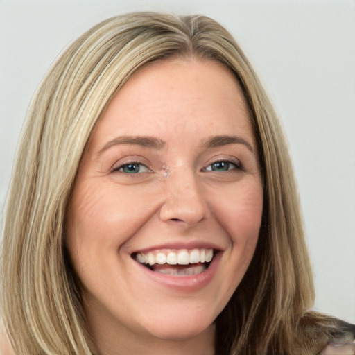 Joyful white young-adult female with long  brown hair and green eyes