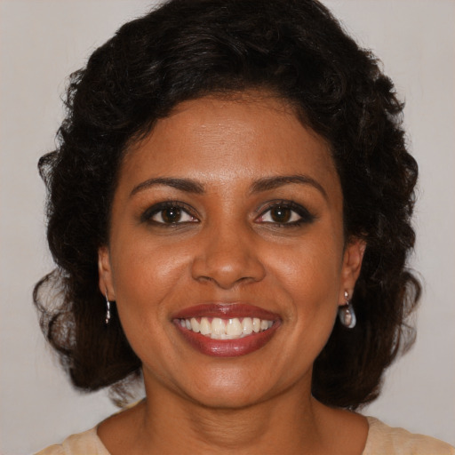 Joyful black young-adult female with medium  brown hair and brown eyes