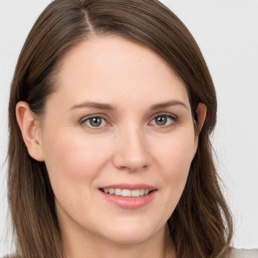 Joyful white young-adult female with long  brown hair and brown eyes